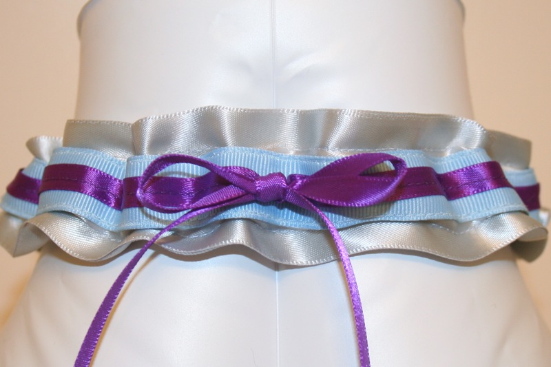It is silver satin with a light blue stripe and a dark purple satin bow