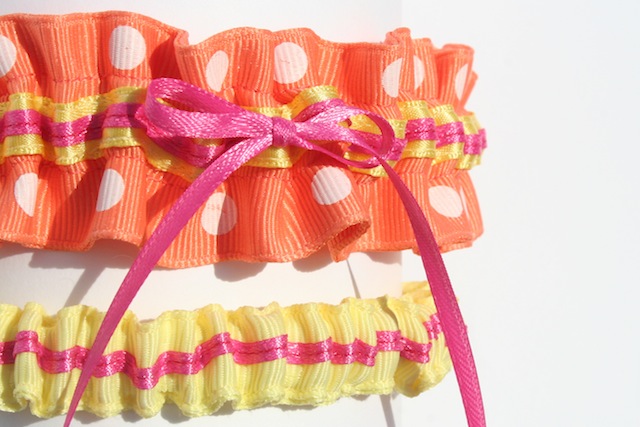 The matching tossing garter is lemon yellow grosgrain with a hot pink satin