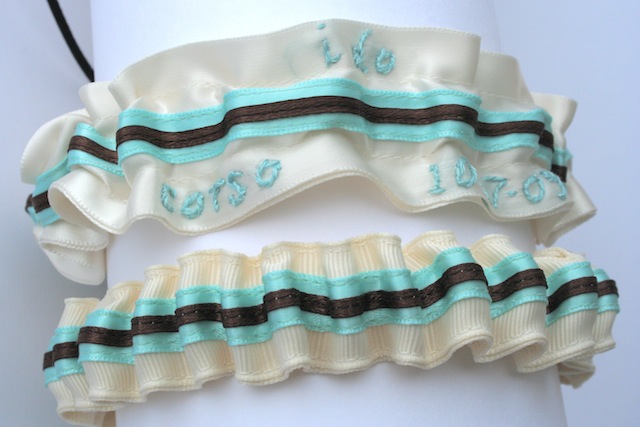 The main wedding garter in Melissa's set is ivory with a Tiffany blue satin